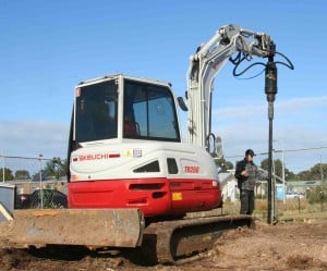 Excavator and auger combo boosting piling capability